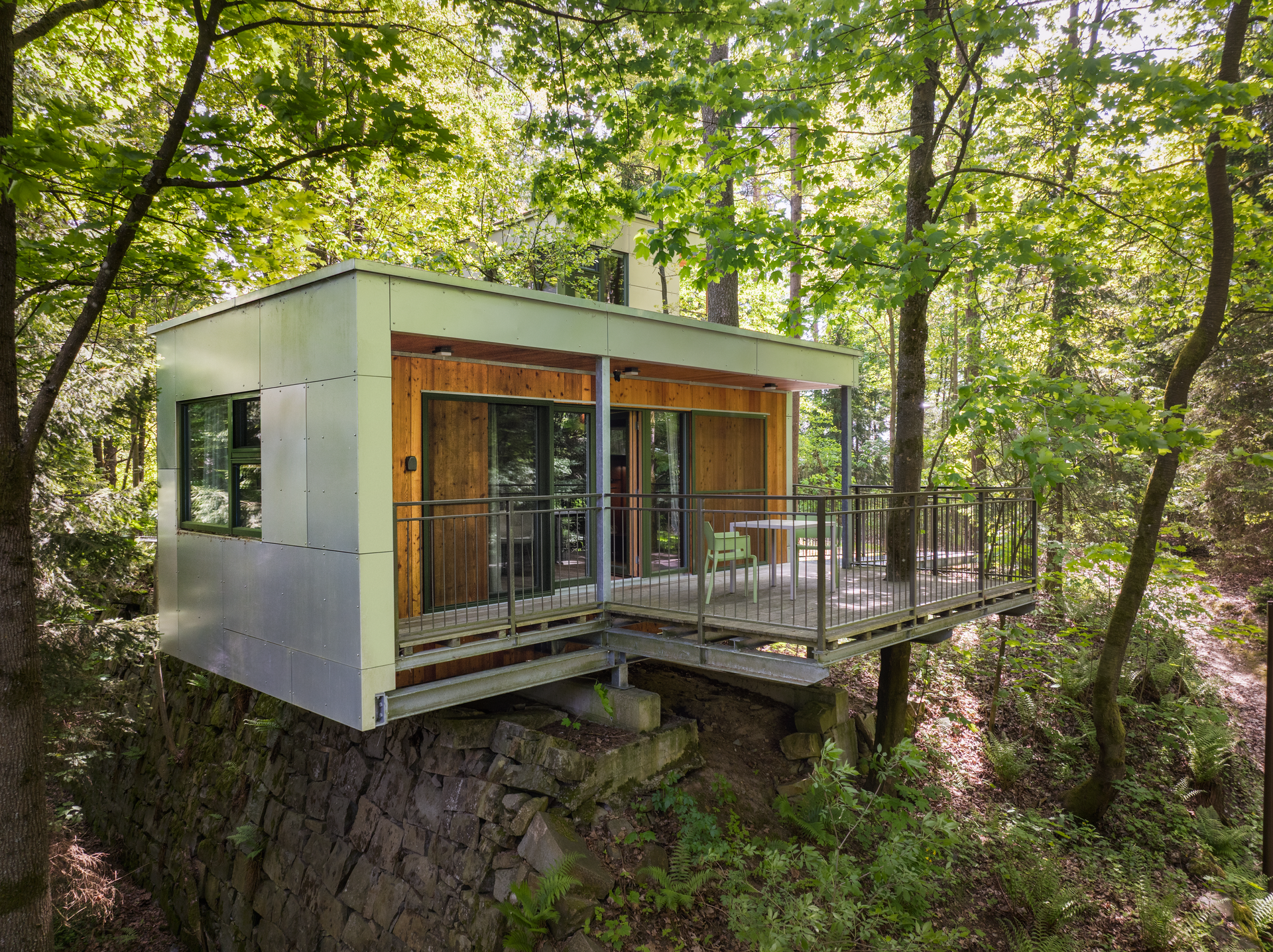 Modern tree house with terrace in the forest.
